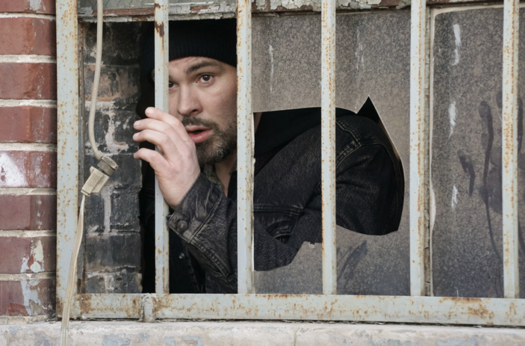 Adam Ruzek looks out the window hoping that this isn't how his life ends on Chicago PD